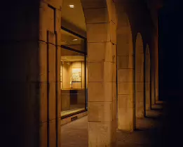 Amber Silence A fine art night photograph capturing the tranquil beauty of a stone arcade bathed in warm light. The soft glow and rhythmic columns evoke stillness, elegance,...