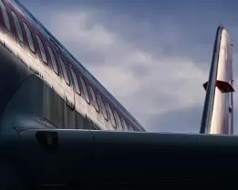 Winged Geometry A rear view of a commercial jet reveals clean metallic lines under a moody sky.