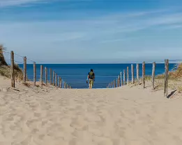 Seaside Escape A barefoot figure walks down a sandy path toward the calm ocean horizon.