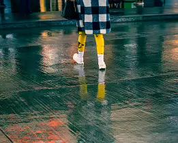 Yellow Echo A splash of yellow cuts across rain-soaked pavement, mirrored in a shifting pool of neon reflections.